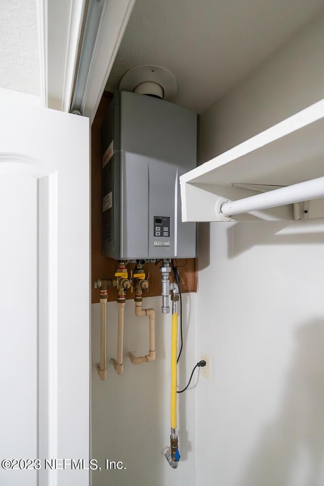 utility room with tankless water heater