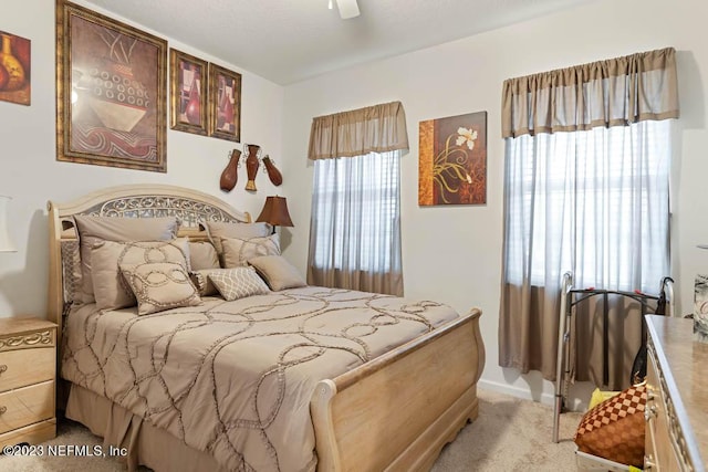 bedroom featuring ceiling fan and light colored carpet