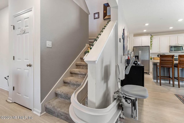 stairway with hardwood / wood-style flooring