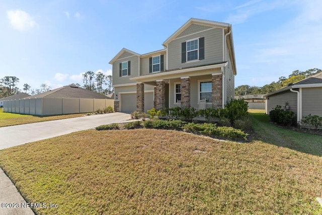 view of front of house with a garage, a front yard, and covered porch