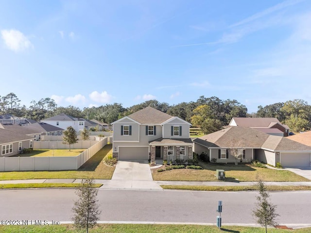 view of front property featuring a garage and a front lawn