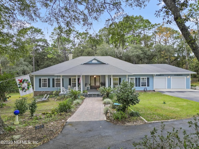 ranch-style home featuring a porch, a garage, and a front lawn