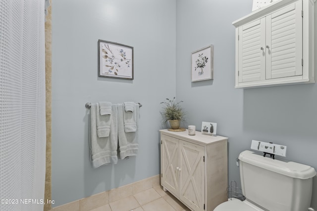 bathroom with tile patterned flooring and toilet