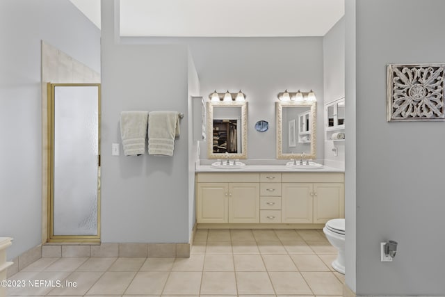 bathroom with vanity, toilet, an enclosed shower, and tile patterned flooring