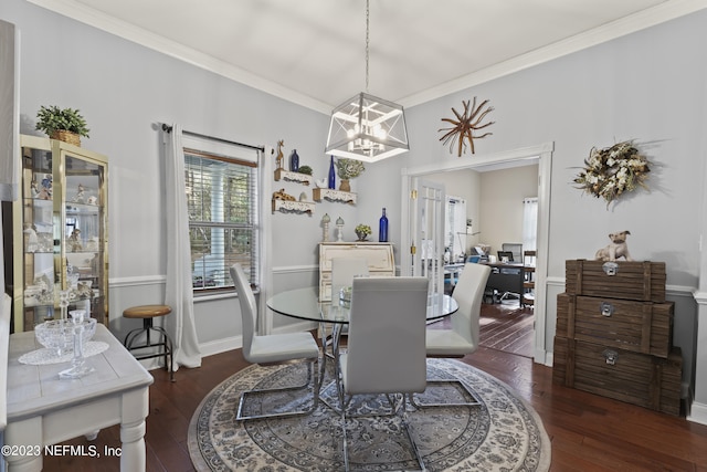 dining room with ornamental molding, dark hardwood / wood-style floors, and a chandelier