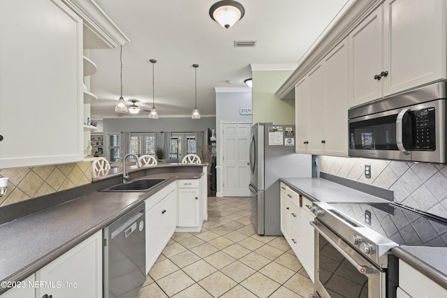 kitchen with sink, white cabinetry, crown molding, hanging light fixtures, and stainless steel appliances