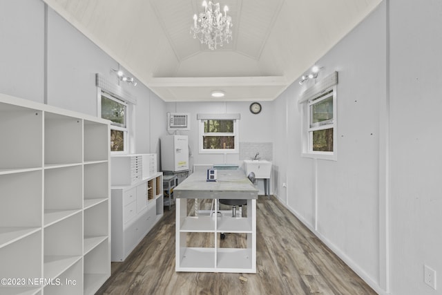 dining room featuring lofted ceiling, a notable chandelier, wood-type flooring, and a wall mounted AC