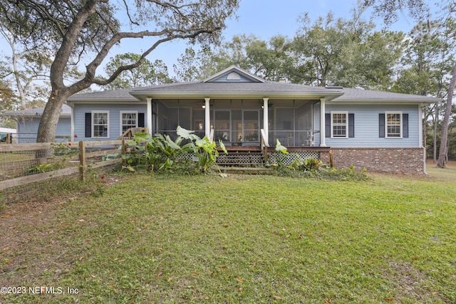 view of front of home featuring a front lawn and a sunroom