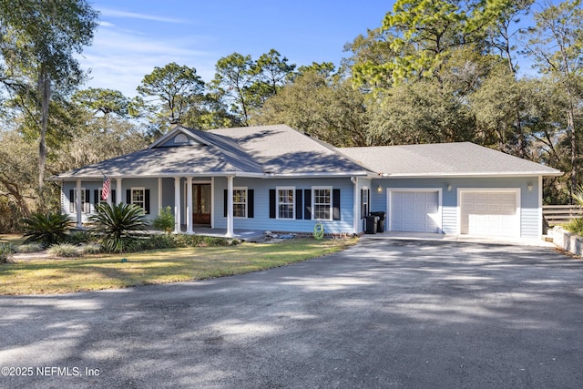 single story home featuring a garage and a front lawn