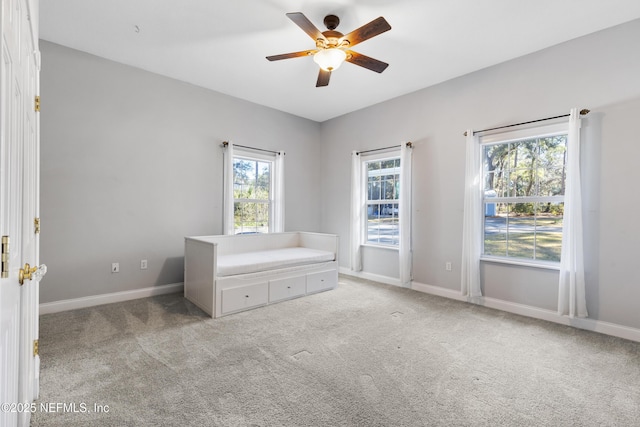 unfurnished bedroom featuring light carpet and ceiling fan