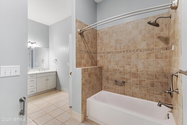 bathroom with vanity, tiled shower / bath combo, and tile patterned flooring