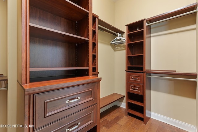 spacious closet featuring hardwood / wood-style flooring