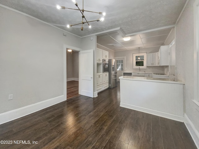 kitchen with a textured ceiling, kitchen peninsula, white cabinetry, and dark hardwood / wood-style floors