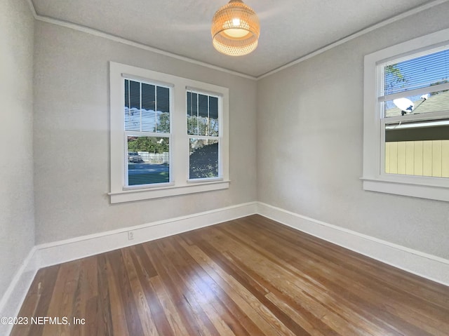 spare room with hardwood / wood-style floors and ornamental molding