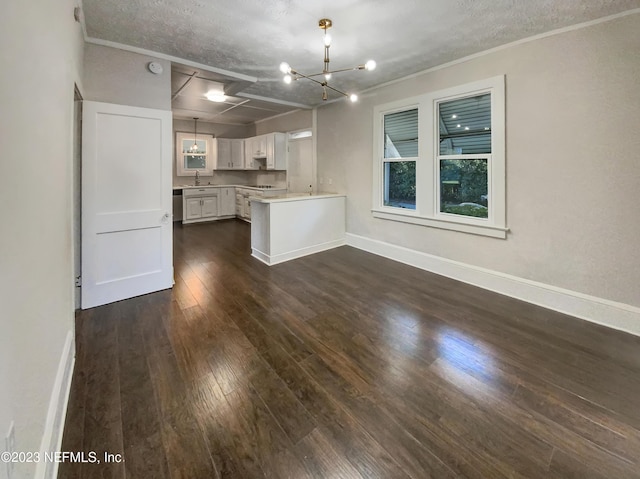 kitchen with a textured ceiling, dark hardwood / wood-style flooring, white cabinets, and decorative light fixtures