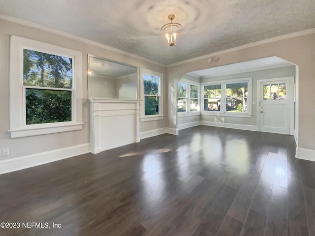 unfurnished living room with dark hardwood / wood-style flooring, ornamental molding, and a textured ceiling