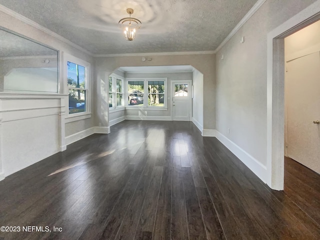 interior space featuring dark hardwood / wood-style floors, crown molding, and a textured ceiling