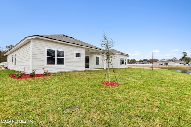 rear view of property with a lawn