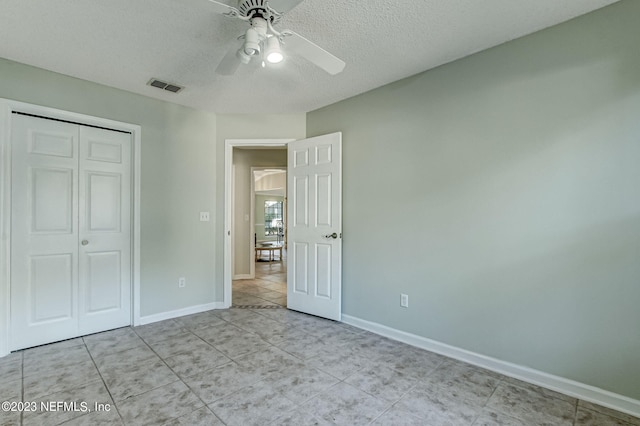 unfurnished bedroom featuring a closet, visible vents, ceiling fan, and baseboards