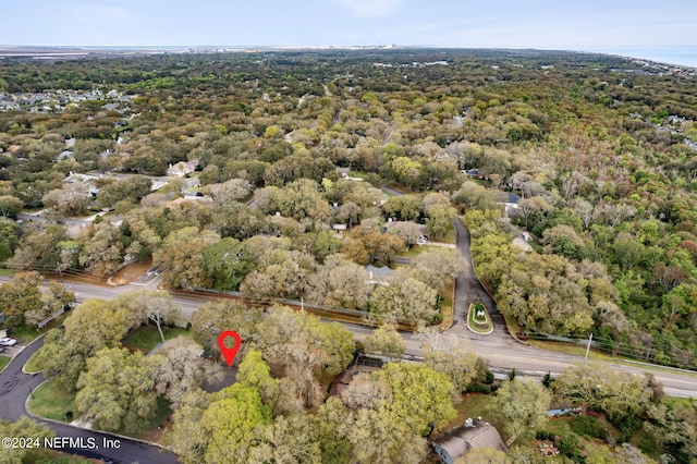 birds eye view of property featuring a wooded view