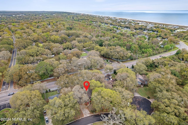 drone / aerial view featuring a forest view and a water view