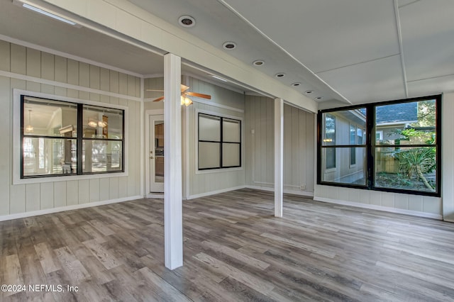 spare room featuring ceiling fan, wood finished floors, and baseboards