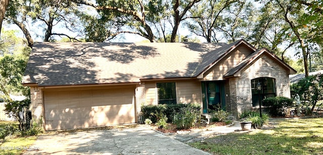 view of front of property with a garage and a front yard