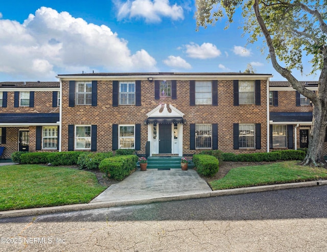 4358 Timuquana Rd Unit 205, Jacksonville, FL 32210 - view of front of property featuring brick siding and a front lawn