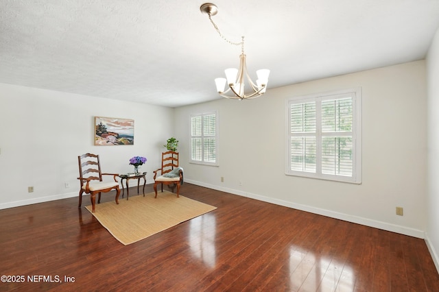 4358 Timuquana Rd Unit 205, Jacksonville, FL 32210 - living area featuring a chandelier, baseboards, and wood finished floors
