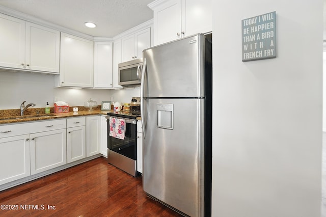 4358 Timuquana Rd Unit 205, Jacksonville, FL 32210 - kitchen featuring stainless steel appliances, a sink, white cabinetry, dark wood finished floors, and stone counters