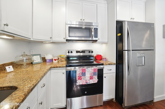 4358 Timuquana Rd Unit 205, Jacksonville, FL 32210 - kitchen with appliances with stainless steel finishes, white cabinets, dark wood-type flooring, and light stone countertops