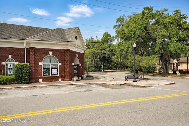 4358 Timuquana Rd Unit 205, Jacksonville, FL 32210 - view of home's exterior featuring brick siding and roof with shingles