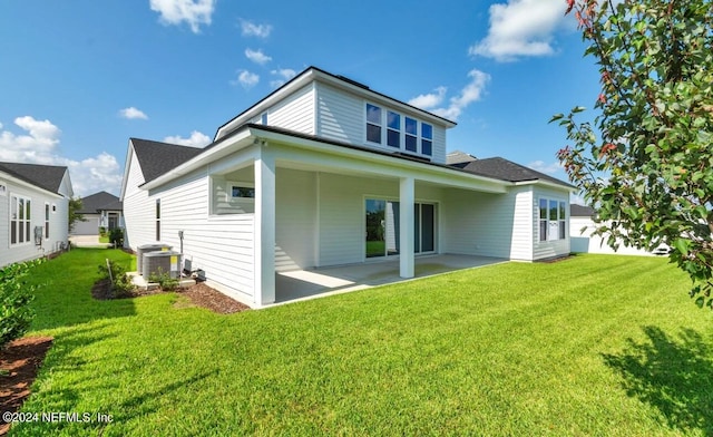 back of property featuring a patio, a yard, and cooling unit