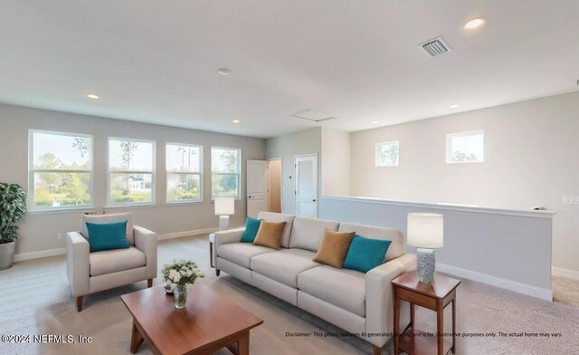 living area featuring a wealth of natural light, light carpet, visible vents, and baseboards