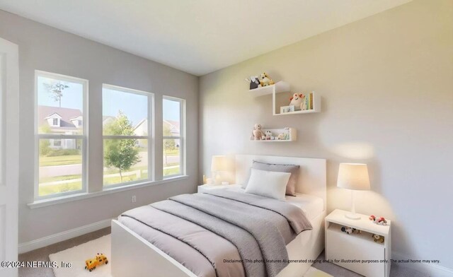 carpeted bedroom featuring baseboards