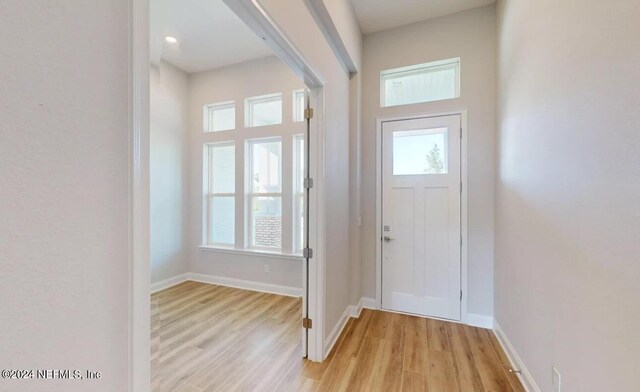 entryway with light wood-style floors and baseboards