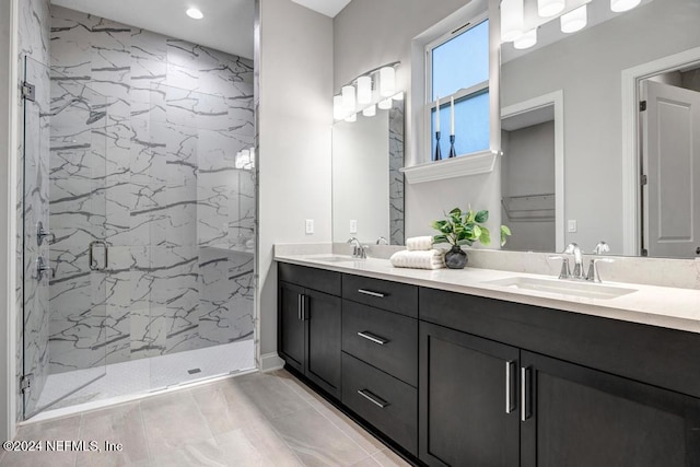 bathroom featuring tiled shower and vanity