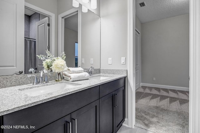 bathroom featuring vanity and a textured ceiling