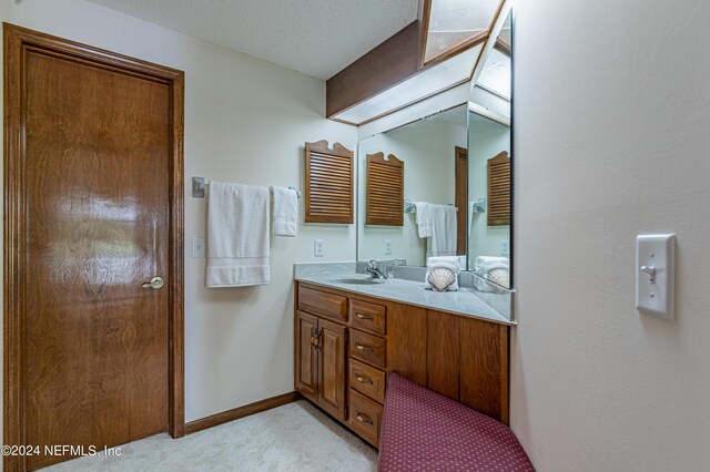 bathroom featuring vanity and a textured ceiling