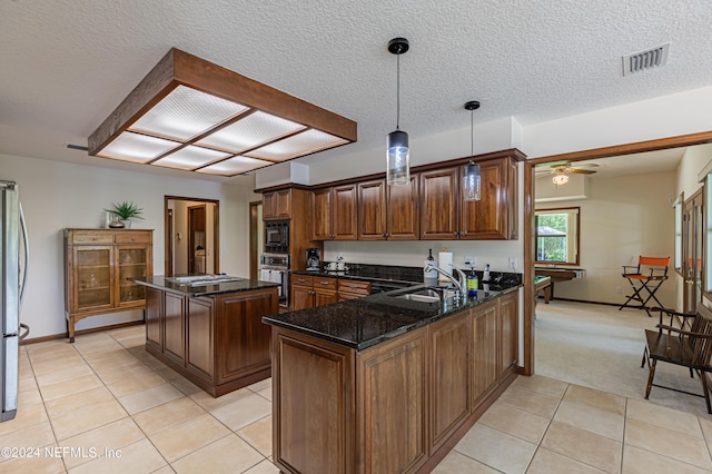 kitchen with appliances with stainless steel finishes, pool table, decorative light fixtures, a kitchen island, and sink