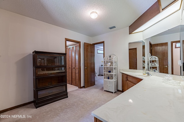 bathroom with a textured ceiling and vanity