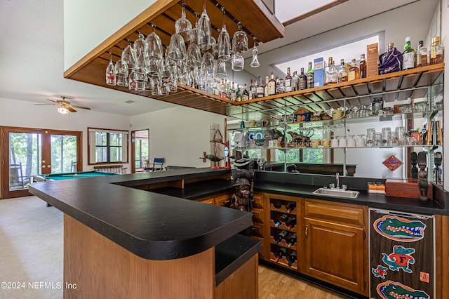 bar with ceiling fan, sink, pool table, and light hardwood / wood-style floors