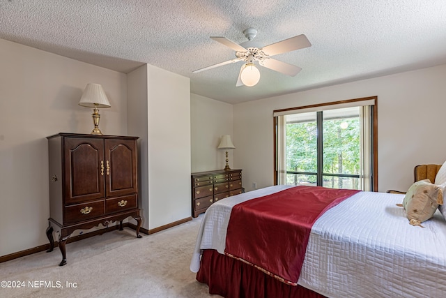 bedroom with ceiling fan, a textured ceiling, and light carpet