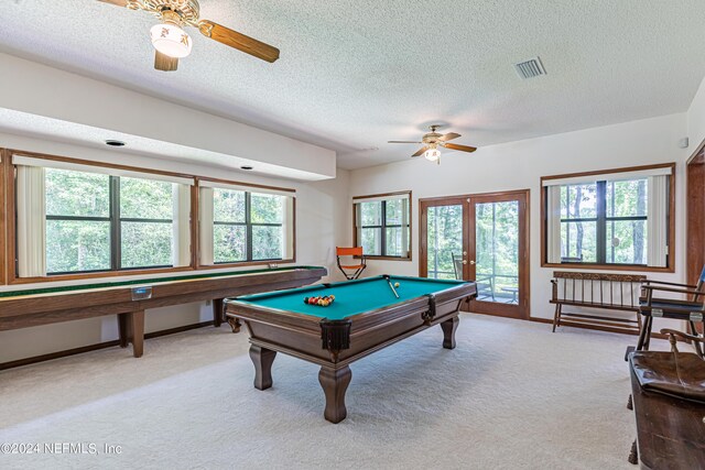 game room with billiards, french doors, light colored carpet, and a textured ceiling