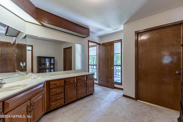 bathroom with vanity and a textured ceiling