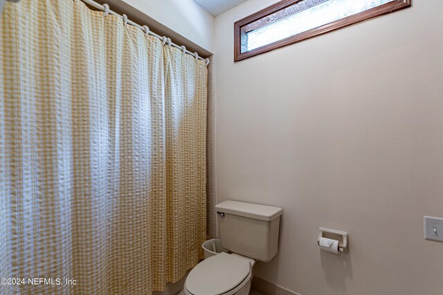 bathroom with toilet and walk in shower