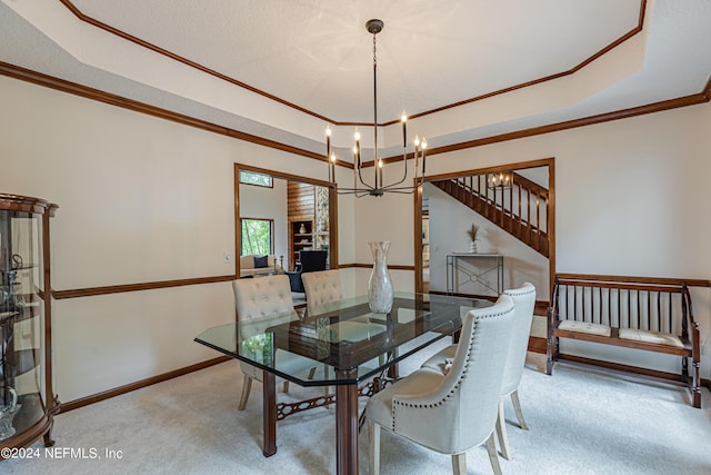 dining area with light colored carpet, crown molding, a raised ceiling, and a chandelier