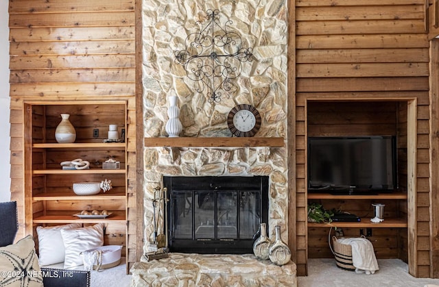 living room with carpet and a fireplace