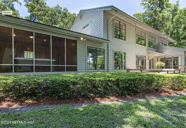 back of house featuring a sunroom