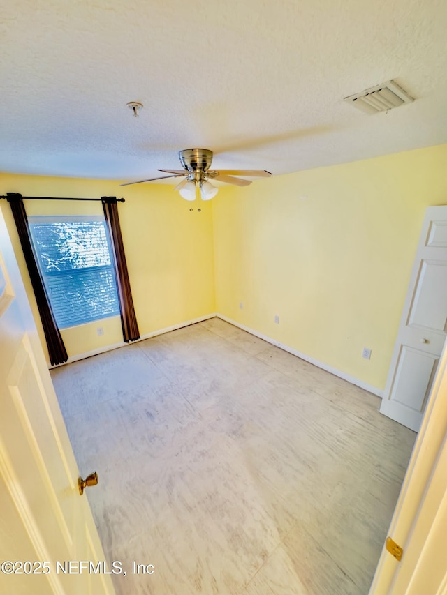 spare room with ceiling fan and a textured ceiling